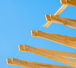 
yellow pine planks against a blue sky, exposed by level