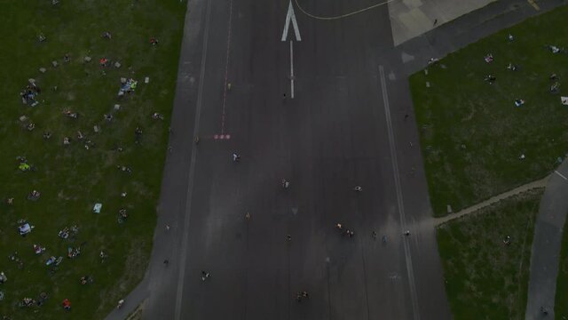 Aerial drone shot of people at Berlin Tempelhof Airport, an area now used as a recreational area after the airport closed in 2008.