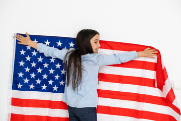 Cute little girl and USA flag on background