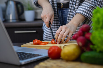 woman cutting tomatoes on the board home kitchen