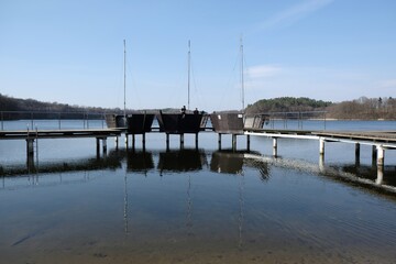 Obraz premium Wooden pier with elements looking like boats and bathing on Lake Struga, Kociewie, Poland