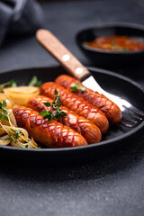 Grilled sausages with roasted onion