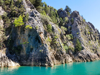 Seascape against the backdrop of mountains on a cloudless sunny day.