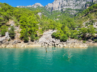 Seascape against the backdrop of mountains on a cloudless sunny day.