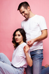 young cheerful caucasian couple together having fun on pink background, guy ang girl modern relationship, lifestyle people concept