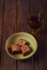 Brownie in a green plate. On a wooden table