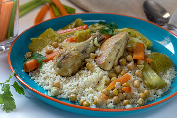 Chicken stew with vegetables, hummus and couscous.