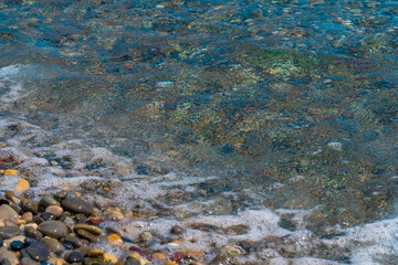Pebble stones on the shore close up in the mediterranean beach