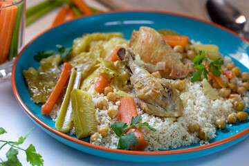 Chicken stew with vegetables, hummus and couscous.