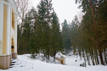 Entrance to the chapel on the left side. Path in the city park. 
