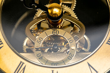 Close Up of the mechanisms and gears of a gold watch clock face