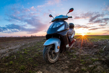 travel by scooter on field roads against the backdrop of fields and sunset © Костянтин Жук