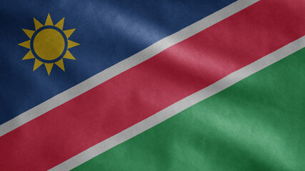 Namibian flag waving in the wind. Close up of Namibia banner blowing soft silk.