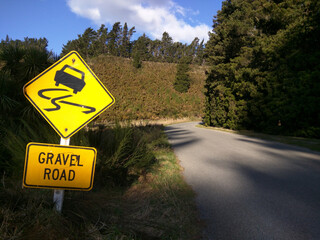 a road up the mountain in new zealand with a danger sign