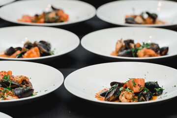 the chef prepares a seafood dish. the cook sets the table for the banquet