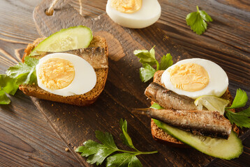  sandwiches with rye bread, sprats, fresh cucumber and boiled eggs