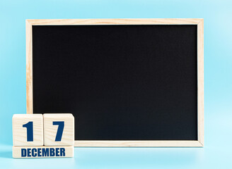December 17th. Day 17 of month, Cube calendar with date, empty frame on light blue background. Place for your text. Winter month, day of the year concept