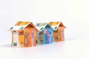 abstract houses from 50 and 20 euro banknotes isolated on a light background, home loan concept