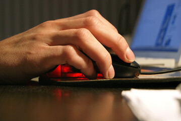 Close-up of a boy's hand holding a mouse.
Computer science and pc activities.