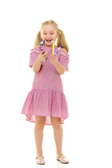 The girl is a sweet tooth, she is very happy about the candy.