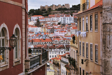 Fototapeta na wymiar Portuguese colorful houses in Lisbon. Roofs and windows in the Portuguese capital on a spring day.