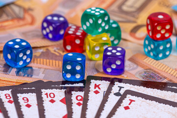 playing cards and colored dice against the background of euro banknotes, gambling concept