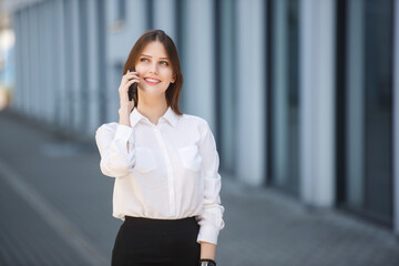 Smiling young girl talking on the mobile phone