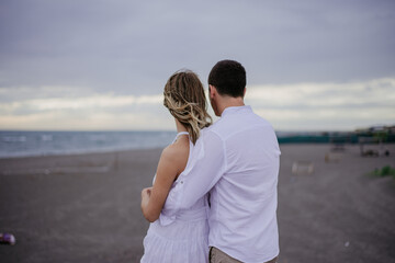 couple on the beach on their wedding day bride and groom watching sunset