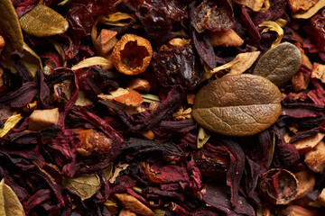 Tea leaves with hibiscus as a background.