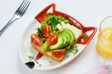 Children's vegetarian sandwich - funny faces. Creative healthy toast. Top view. Healthy vegan food, vegetarian food concept