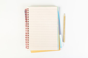 top view of an open notebook with a pencil on a gray background, school notebooks with a spiral spring, office notepad. desktop concept, learning