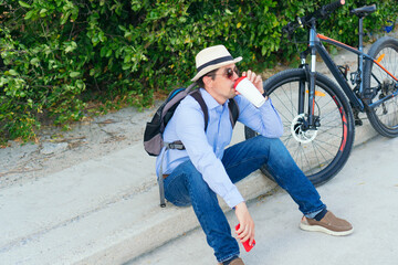 Businessman drinking coffee and checking his cell phone on the street