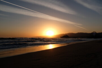 Sunset at Santa Monica Beach, California. The golden color of the sand.