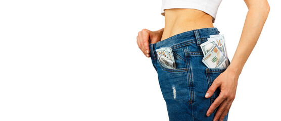 Woman in jeans with hundred dollars inside