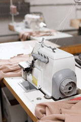overlock machine with cloth on the seamstress's desktop