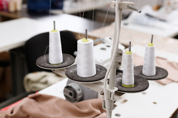 threads with an overlock machine at work