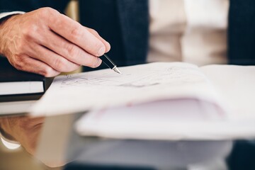 Lawyer, notary public signing document, testament or contract.