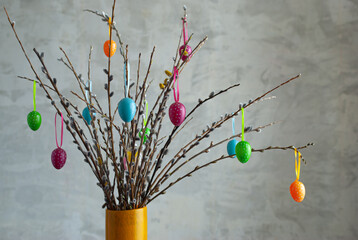 easter eggs on a gray background.colorful Easter eggs decorate the willow branches