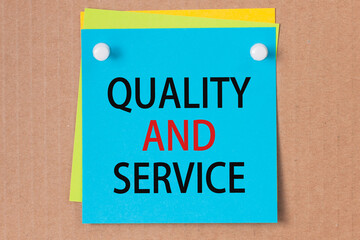 QUALITY AND SERVICE written on blue paper and pinned on corkboard,