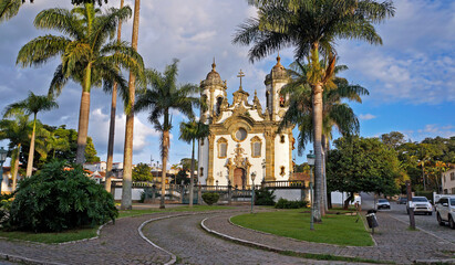 Fototapeta na wymiar Baroque church and palm trees in Sao Joao del Rei, Brazil 