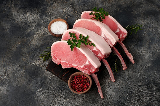 Raw fresh rack of pork on wooden board