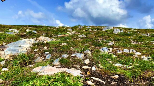 Mountain peak with wood cross on a summer day - right to left camera slide