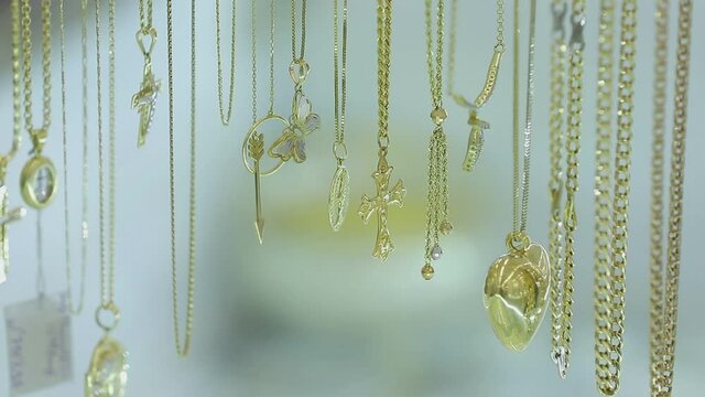 Expensive  jewelry on the counter of a jewellery store . Various diamonds  sapphires   gold earrings bracelets  rings  necklaces with price tags . Beautiful bijouterie on shelves and mannequins 