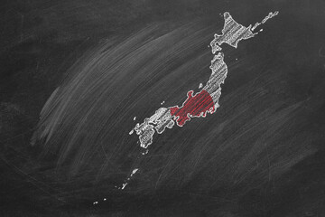 Country map and flag of Japan drawing with chalk on a blackboard. One of a large series of maps and flags of different countries. Education, travel, study abroad concept.