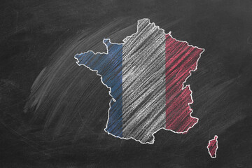 Country map and flag of France drawing with chalk on a blackboard. One of a large series of maps and flags of different countries. Education, travel, study abroad concept.
