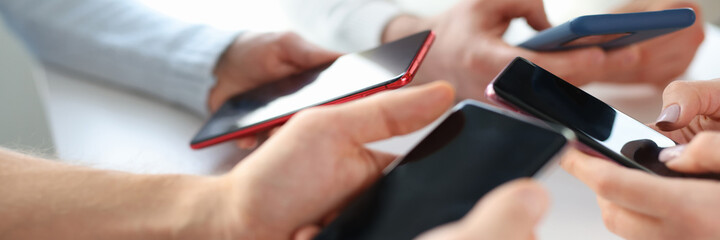 Group of business people are holding mobile phones in office