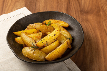 Roasted potatoes with rosemary on the plate.