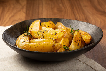 Roasted potatoes with rosemary on the plate.