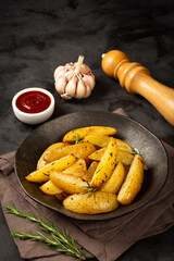 Roasted potatoes with rosemary on the plate.