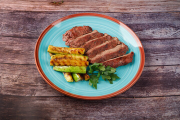 Sliced sirloin Steak Roast Beef on a dark wooden table background.